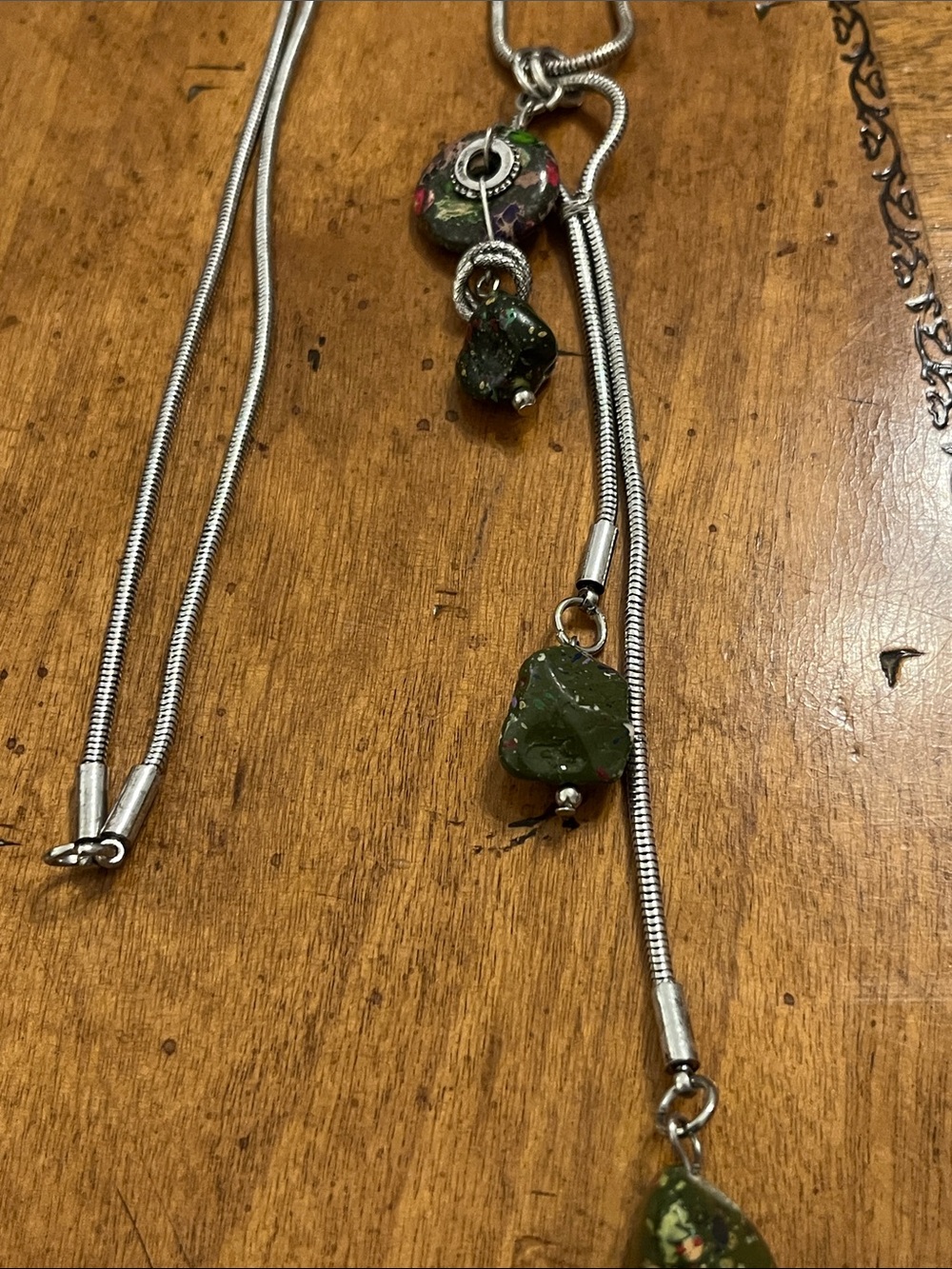 Lariat style snake chain necklace with green faux gems